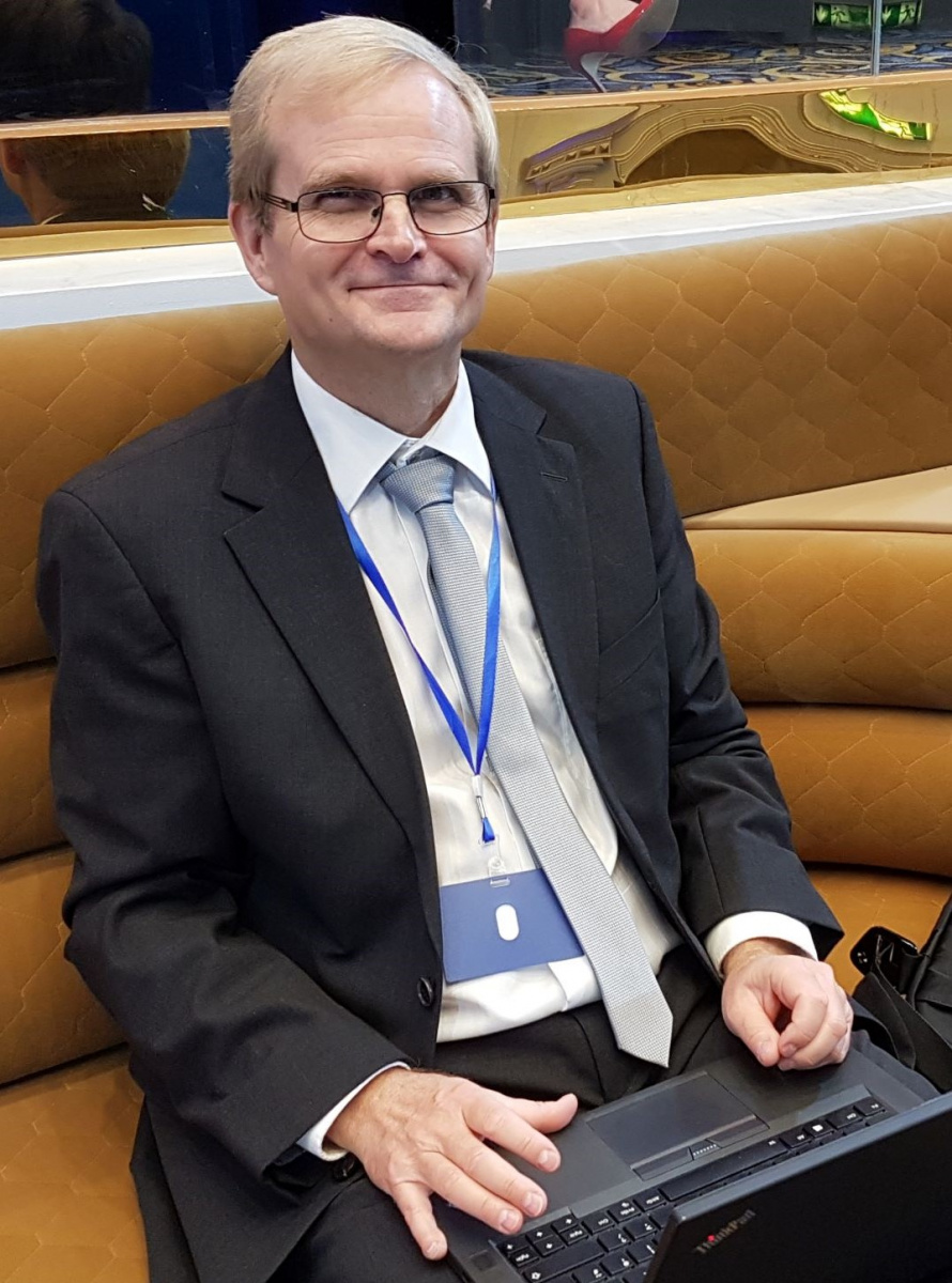 Vegard in his “office” (i.e. with his laptop and computer bag) in the conference hall for the IOTA Annual Conference “Tax compliance technology showroom” in Tbilisi in October 2019